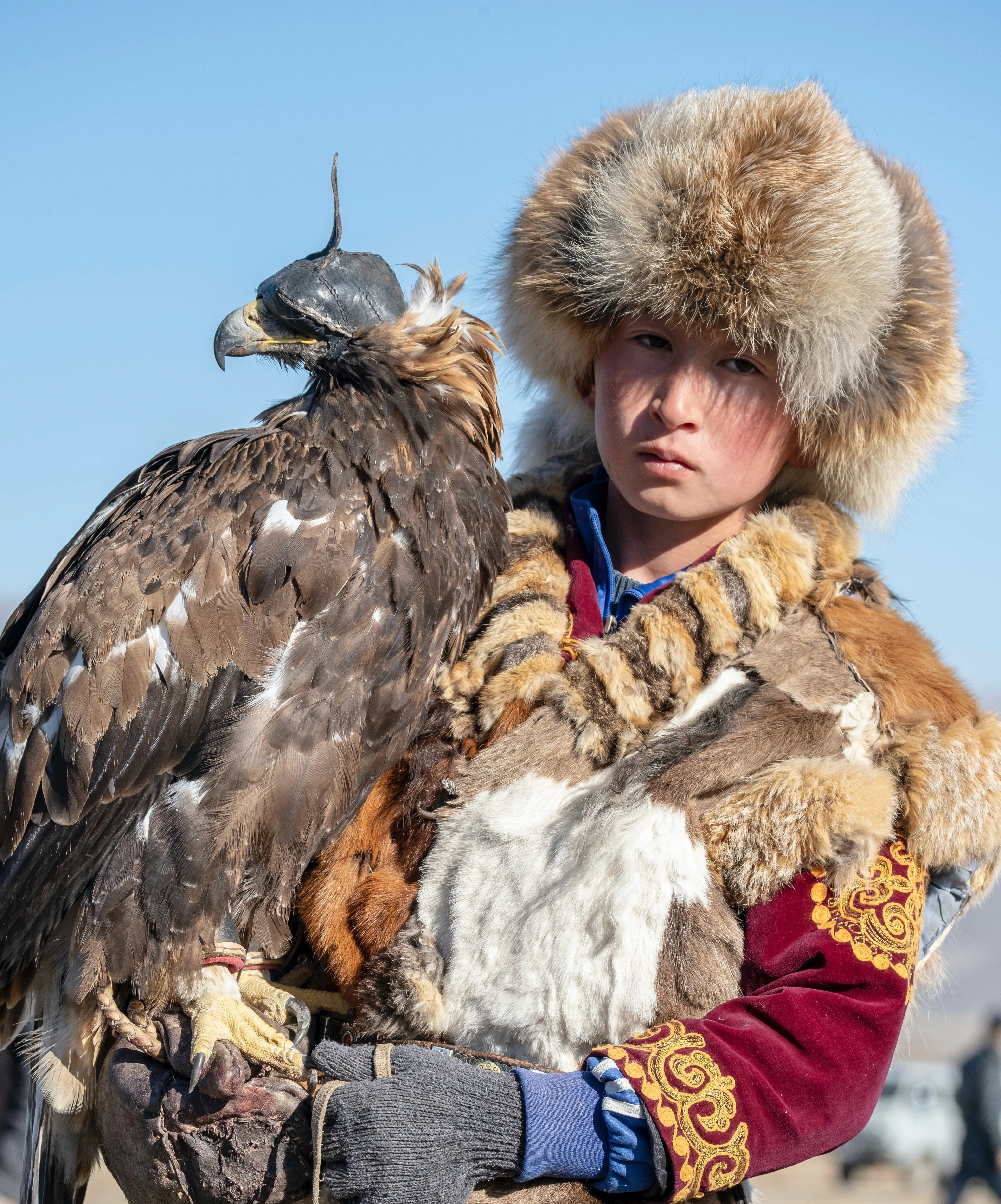 Young Eagle hunter with his Golden Eagle in Mongolia